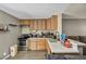 Well-lit kitchen area with wood cabinets, a breakfast bar, and stainless-steel appliances at 301 E Van Wagenen St, Henderson, NV 89015