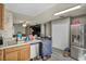 Modern kitchen with stainless steel appliances and light wood cabinetry next to the living room at 301 E Van Wagenen St, Henderson, NV 89015