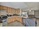 Efficient kitchen featuring light wood cabinets, modern appliances, and a breakfast bar at 301 E Van Wagenen St, Henderson, NV 89015