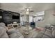 Open-concept living room with gray walls and a decorative accent wall with a ceiling fan at 301 E Van Wagenen St, Henderson, NV 89015