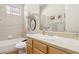 The bathroom features a tub-shower combination, a light wood vanity, and neutral tile floors at 304 Cambrian Ridge Ct, Las Vegas, NV 89144