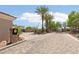 Gated entrance to a community featuring palm trees and desert landscaping at 304 Cambrian Ridge Ct, Las Vegas, NV 89144