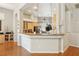 Inviting kitchen with hardwood floors, a breakfast bar, and a view of the adjacent dining area at 304 Cambrian Ridge Ct, Las Vegas, NV 89144