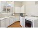 The laundry room features a stainless steel washer and dryer, white cabinets, and ample counter space at 304 Cambrian Ridge Ct, Las Vegas, NV 89144