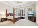 The main bedroom is spacious with a four-poster bed, a ceiling fan, natural light, and neutral decor at 304 Cambrian Ridge Ct, Las Vegas, NV 89144
