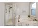 Clean bathroom offering a glass-enclosed shower, a soaking tub, and neutral tones at 3099 Palmdesert Way, Las Vegas, NV 89120