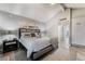 Bright bedroom featuring modern decor, a comfortable bed, and access to an ensuite bathroom at 3099 Palmdesert Way, Las Vegas, NV 89120