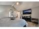 Cozy bedroom showcasing a large TV, a dresser, and a comfortable seating area at 3099 Palmdesert Way, Las Vegas, NV 89120
