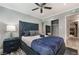 Comfortable bedroom featuring a tufted headboard, ceiling fan and mirrored closet at 3099 Palmdesert Way, Las Vegas, NV 89120