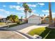 Inviting single-story home with lush lawn, mature trees, and a spacious two car garage at 3099 Palmdesert Way, Las Vegas, NV 89120
