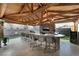 Entertainer's outdoor bar and kitchen featuring a TV, built-in grill, sink and seating at 3099 Palmdesert Way, Las Vegas, NV 89120