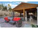 Outdoor living space with a patio, fire pit, and covered dining area at 3099 Palmdesert Way, Las Vegas, NV 89120