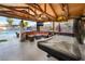 Covered outdoor living space featuring a pool table and lounge seating near the pool at 3099 Palmdesert Way, Las Vegas, NV 89120