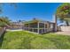 Large, grassy backyard with enclosed, screened lanai, pool, and privacy fencing at 318 Heather Dr, Henderson, NV 89002