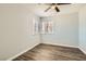 Cozy bedroom featuring modern laminate wood flooring, neutral paint, and natural light at 318 Heather Dr, Henderson, NV 89002