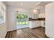 Eat-in kitchen with white cabinetry, stainless steel sink, and sliding doors leading to backyard at 318 Heather Dr, Henderson, NV 89002