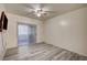 This bedroom has hardwood floors, a ceiling fan, and a sliding glass door leading to a balcony at 3400 Cabana Dr # 1068, Las Vegas, NV 89122