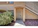 Charming condo entrance featuring a secure metal gate, adjacent stairway and a blooming bush for added curb appeal at 3400 Cabana Dr # 1068, Las Vegas, NV 89122