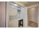 This laundry closet holds a stacked washer and dryer set with shelving at 3400 Cabana Dr # 1068, Las Vegas, NV 89122