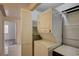 This laundry closet holds a stacked washer and dryer set with shelving at 3400 Cabana Dr # 1068, Las Vegas, NV 89122