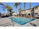 Community pool with palm trees, with stairs and rails for easy access, and plenty of room for swimming at 3400 Cabana Dr # 1068, Las Vegas, NV 89122