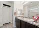 Well-lit bathroom featuring a double sink vanity with granite countertops at 3543 E Malheur Ave, Pahrump, NV 89061