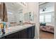 Bathroom featuring double sinks, granite countertops, and neutral decor at 3543 E Malheur Ave, Pahrump, NV 89061
