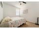 Cozy bedroom with ceiling fan, comfortable bed with floral quilt, and a sunny window at 3543 E Malheur Ave, Pahrump, NV 89061