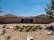 Entrance to Burson Ranch community featuring desert landscaping with vibrant flower beds around the prominent community sign at 3543 E Malheur Ave, Pahrump, NV 89061