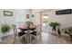 Bright dining area with stylish table and chairs, sliding door to the backyard, and tile floors at 3543 E Malheur Ave, Pahrump, NV 89061