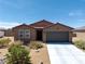 Inviting single-story home with a neutral-colored exterior and desert landscaping at 3543 E Malheur Ave, Pahrump, NV 89061