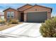 Inviting single-story home with a two-car garage and desert landscaping at 3543 E Malheur Ave, Pahrump, NV 89061