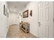 Neutral hallway featuring tile flooring, decorative wall art, and access to various rooms at 3543 E Malheur Ave, Pahrump, NV 89061