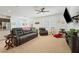 Open-concept living room boasts a flat-screen TV, plush leather sofas, and plenty of natural light at 3543 E Malheur Ave, Pahrump, NV 89061