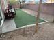 Private backyard featuring an artificial lawn, patio and rock landscaping at 3928 Ropers Ranch St, North Las Vegas, NV 89032
