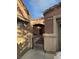 Charming home features an arched porch, metal gate, and desert landscaping at 3928 Ropers Ranch St, North Las Vegas, NV 89032