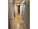Bright hallway with tile flooring, neutral walls, and doors leading to various rooms at 3928 Ropers Ranch St, North Las Vegas, NV 89032