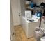 Practical laundry room with washer, dryer, and shelving for storage at 3928 Ropers Ranch St, North Las Vegas, NV 89032