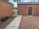 Home featuring a gated side yard with gravel and desert landscaping at 3928 Ropers Ranch St, North Las Vegas, NV 89032