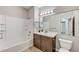Bathroom with vanity, mirror, and tiled shower-tub combo at 3930 Legend Hills St # 102, Las Vegas, NV 89129