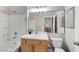 Bathroom with a white tub and shower combo, wood vanity, and a large mirror at 3930 Legend Hills St # 102, Las Vegas, NV 89129