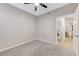 Bedroom featuring a ceiling fan, carpet, and an ensuite bathroom and laundry room at 3930 Legend Hills St # 102, Las Vegas, NV 89129