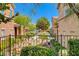 Charming townhome community featuring lush landscaping, vibrant flowers, and stucco exteriors at 3930 Legend Hills St # 102, Las Vegas, NV 89129