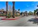 Gated community entrance featuring mature trees, shrubbery and professional landscaping at 3930 Legend Hills St # 102, Las Vegas, NV 89129