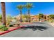 Gated community entrance with palm trees and mature shrubbery at 3930 Legend Hills St # 102, Las Vegas, NV 89129