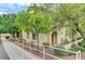 Charming exterior view of a two-story residential building with green landscaping and walkway at 3930 Legend Hills St # 102, Las Vegas, NV 89129