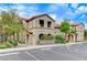 A two-story building featuring tile roofing, archways, and well-manicured landscaping at 3930 Legend Hills St # 102, Las Vegas, NV 89129