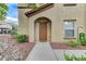 Close-up of the building's entrance featuring an arched doorway and neutral exterior at 3930 Legend Hills St # 102, Las Vegas, NV 89129