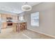 A view into the kitchen with a breakfast bar, seating, and stainless steel appliances at 3930 Legend Hills St # 102, Las Vegas, NV 89129
