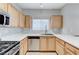 Well-lit kitchen boasts stainless steel appliances, light wood cabinets, and ample counter space at 3930 Legend Hills St # 102, Las Vegas, NV 89129